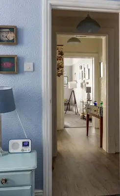 a hallway with a room with blue walls and a table at Beach Shore - SEA VIEWS in Lytham St Annes