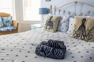 a bed with two pillows on top of it at Beach Shore - SEA VIEWS in Lytham St Annes