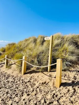 a wooden fence in the sand on a beach at Beach Shore - SEA VIEWS in Lytham St Annes