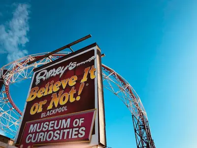 a sign in front of a roller coaster at Kensington Suite Sasco Apartments in Blackpool