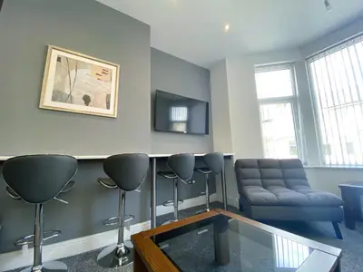 a living room with a couch and a table at Mayfair Suite - 3x Bathrooms Close to Seafront in Blackpool