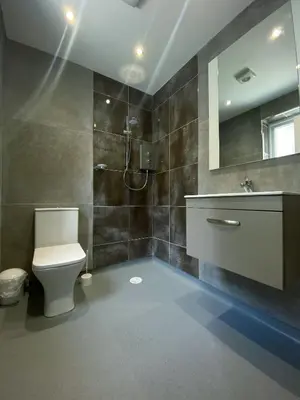 a bathroom with a toilet and a sink and a mirror at Mayfair Suite - 3x Bathrooms Close to Seafront in Blackpool