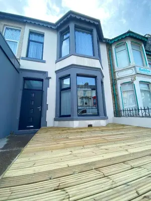 a house with a wooden deck in front of it at Mayfair Suite - 3x Bathrooms Close to Seafront in Blackpool