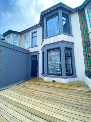 a large house with a wooden deck in front of it at Mayfair Suite - 3x Bathrooms Close to Seafront in Blackpool