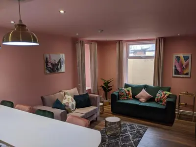 a living room with two couches and a window at Charles Alexander Short Stay - Highcliffe Apartments in Cleveleys