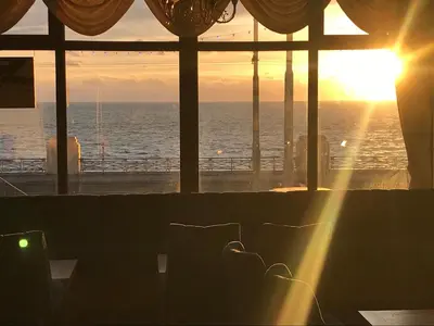 a room with a view of the ocean at sunset at Canasta Hotel in Blackpool