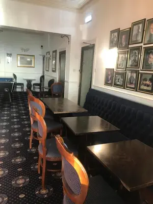 a restaurant with tables and chairs and pictures on the wall at Canasta Hotel in Blackpool