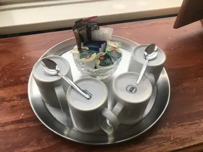a tray with three cups and spoons on a table at Canasta Hotel in Blackpool