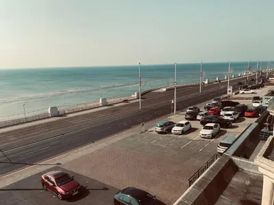 a bunch of cars parked in a parking lot near the beach at Canasta Hotel in Blackpool