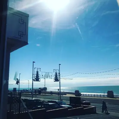 a person walking near a beach with a ski lift at Canasta Hotel in Blackpool