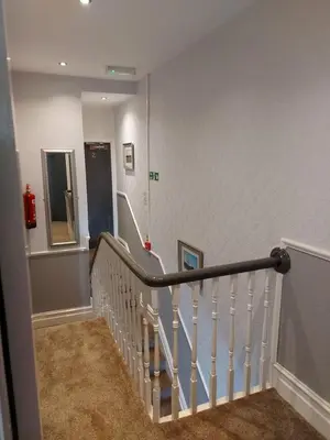 a staircase with a white railing and a stair case at PONDEROSA B&B with free onsite parking and breakfast included in Blackpool
