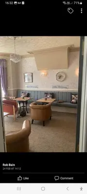 a living room with couches and a table and chairs at PONDEROSA B&B with free onsite parking and breakfast included in Blackpool