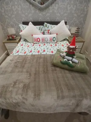 a bed with a christmas gnome sitting on top of it at PONDEROSA B&B with free onsite parking and breakfast included in Blackpool