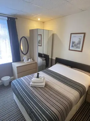a hotel room with a bed with towels on it at Grange House Hotel in Blackpool