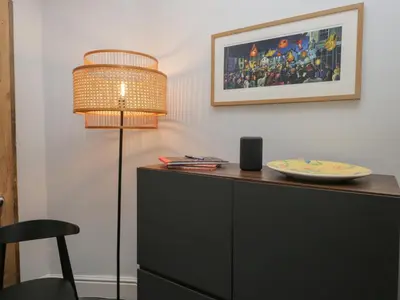 a table with a lamp and a plate on a cabinet at Number Thirty-Nine in Ulverston