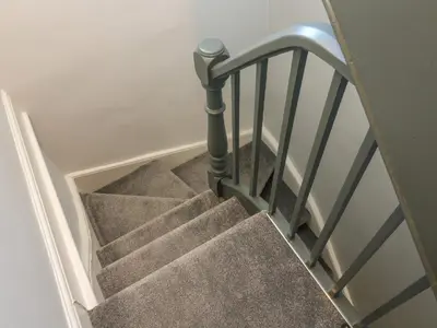 a flight of stairs with a metal railing at Number Thirty-Nine in Ulverston