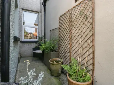 a courtyard with potted plants on the side of a building at Number Thirty-Nine in Ulverston