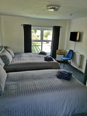 a hotel room with two beds and a window at Red Lion Rooms - Self Check In in Dalton in Furness