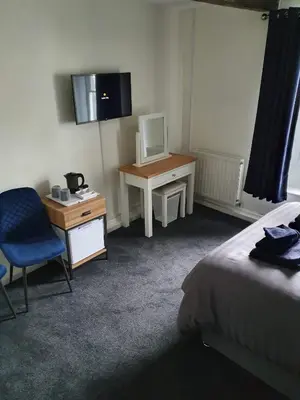 a room with a bed and a desk with a computer at Red Lion Rooms - Self Check In in Dalton in Furness