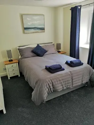 a bedroom with a large bed with two pillows on it at Red Lion Rooms - Self Check In in Dalton in Furness