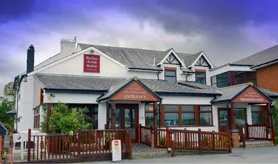 a white building with a fence in front of it at The Birley Arms Hotel in Preston