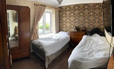 a bedroom with two beds and a window at Sea-front Apartment home-from-home in Blackpool