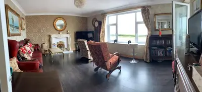 a living room with a couch and a fireplace at Sea-front Apartment home-from-home in Blackpool