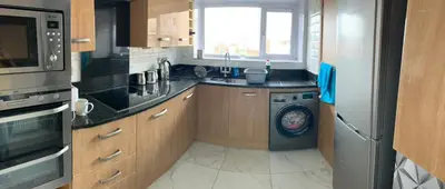 a kitchen with a washer and a washing machine at Sea-front Apartment home-from-home in Blackpool
