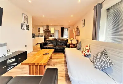 a living room with a couch and a table at Two-bedroom ground-floor apartment Self check-in in Liverpool