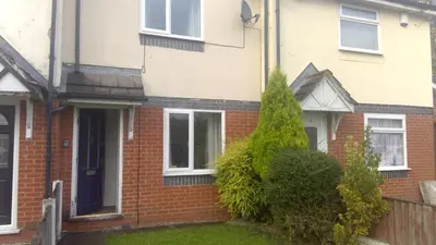 a red brick house with a black door at Cosy house for business travel and pleasure in Bickershaw