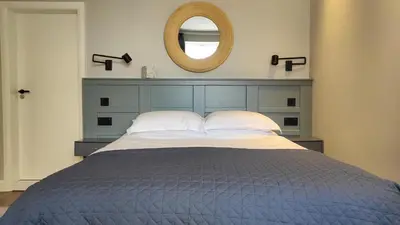 a bedroom with a bed with a mirror above it at Onyx House in Blackpool