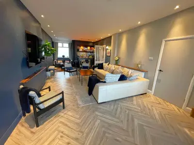 a living room with a white couch and a table at Onyx House in Blackpool