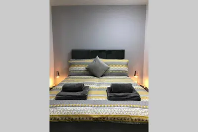 a bedroom with a bed with towels on it at Fishergate ApartHotel 1 - Stylish City Centre Apartment in Preston