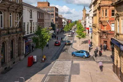 a city street with cars parked on the street at Fishergate ApartHotel 1 - Stylish City Centre Apartment in Preston