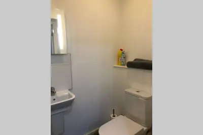 a white bathroom with a toilet and a sink at Fishergate ApartHotel 1 - Stylish City Centre Apartment in Preston