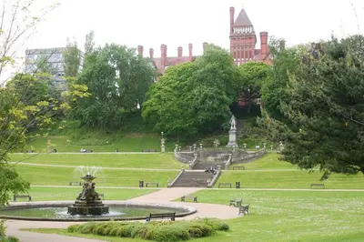 a fountain in a park in front of a building at Fishergate ApartHotel 1 - Stylish City Centre Apartment in Preston