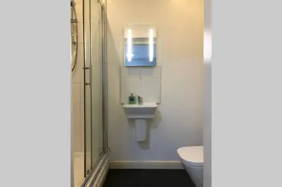 a bathroom with a toilet and a sink and a shower at Fishergate ApartHotel 1 - Stylish City Centre Apartment in Preston