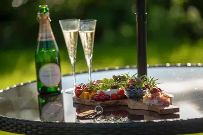 a table with two champagne glasses and fruit on it at Alpaca Fold in Preston