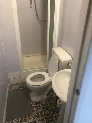 a small bathroom with a toilet and a sink at Northern Pearl Hotel in Blackpool