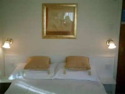 a bed with two pillows and a picture on the wall at Gleneagles - Albert Road in Blackpool