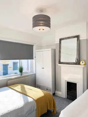 a bedroom with a bed and a fireplace at The Baltic Townhouses by Serviced Living Liverpool in Liverpool