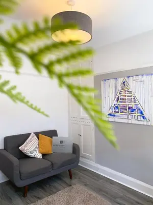 a living room with a couch and a window at The Baltic Townhouses by Serviced Living Liverpool in Liverpool
