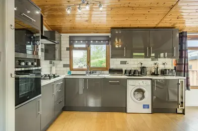 a kitchen with a washing machine and a washer at Lakeview Lodge in Carnforth