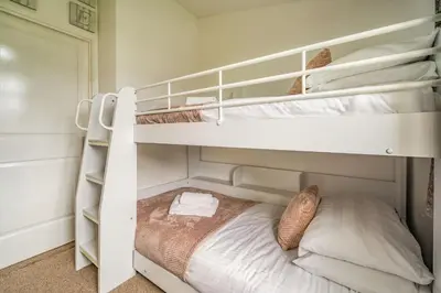 a bedroom with two bunk beds and a bed at Lakeview Lodge in Carnforth