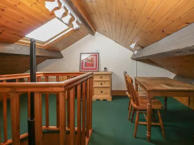 a room with a table and chairs and a window at Shipwreck Cottage in Millom