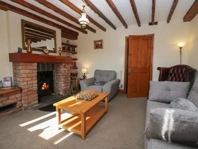 a living room with a couch and a fireplace at Shipwreck Cottage in Millom