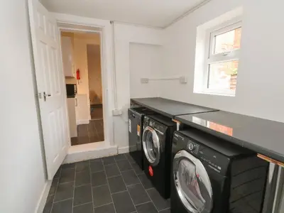 a laundry room with a washer and dryer at St Heliers in Blackpool