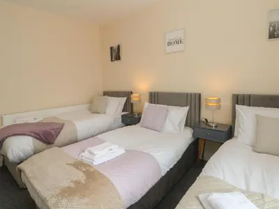 a hotel room with two beds and two tables at St Heliers in Blackpool