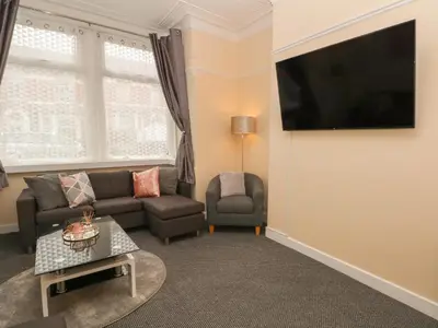 a living room with a couch and a tv at St Heliers in Blackpool
