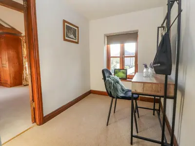 a chair sitting at a table in a room at Clerk Beck Cottage in Ulverston